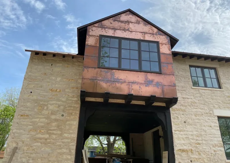 Copper metal panel facade on a stone building for Roof Repair in Kapolei